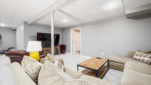 living room with a paneled ceiling and light carpet