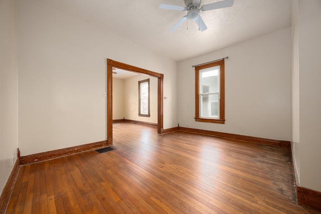 unfurnished room with hardwood / wood-style flooring and ceiling fan