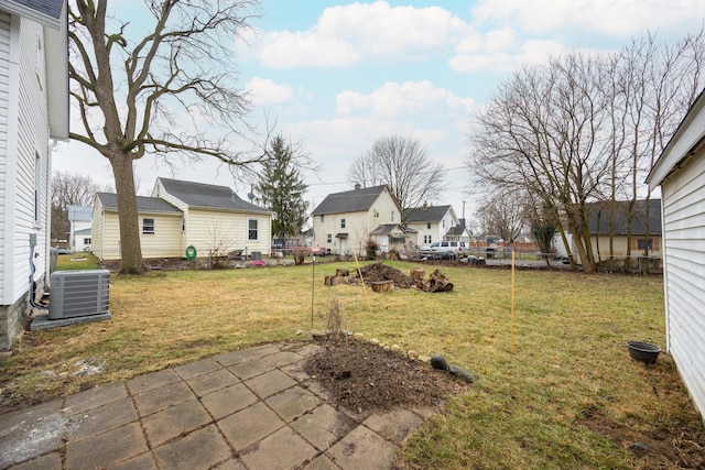 view of yard featuring a patio area and central air condition unit