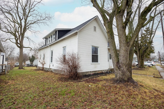 view of home's exterior with a yard