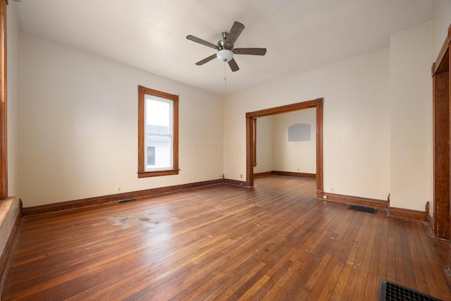 spare room with dark hardwood / wood-style floors and ceiling fan