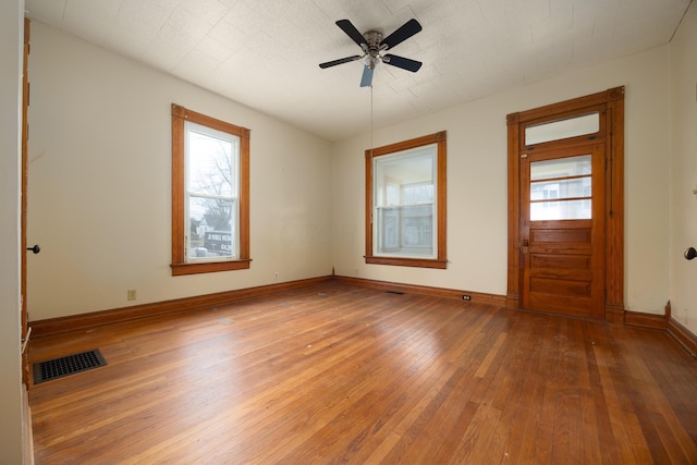 empty room featuring hardwood / wood-style flooring and ceiling fan