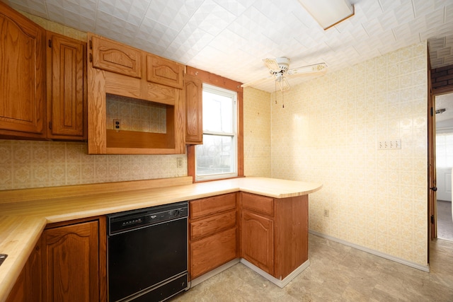 kitchen with ceiling fan, black dishwasher, and kitchen peninsula