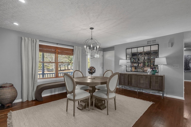 dining room with visible vents, a textured ceiling, and wood finished floors