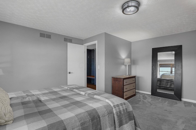 bedroom featuring carpet, a textured ceiling, visible vents, and baseboards