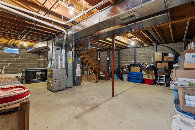 basement featuring heating unit and water heater