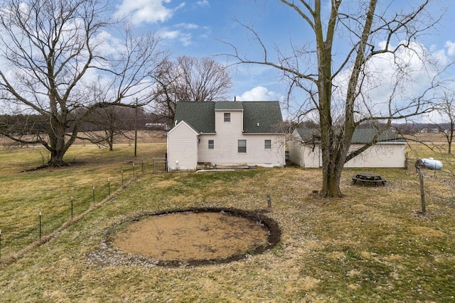 back of house with a lawn