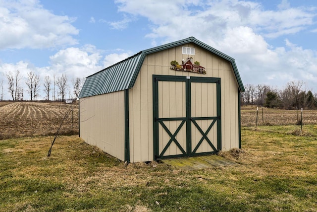 view of outbuilding featuring a yard and a rural view