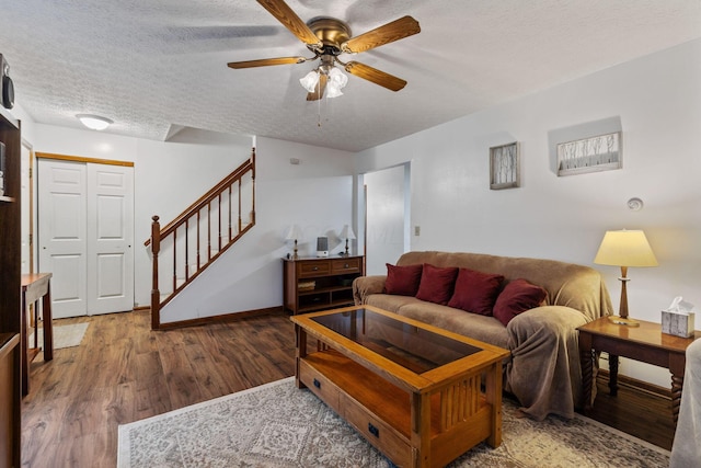 living room featuring hardwood / wood-style floors, a textured ceiling, and ceiling fan