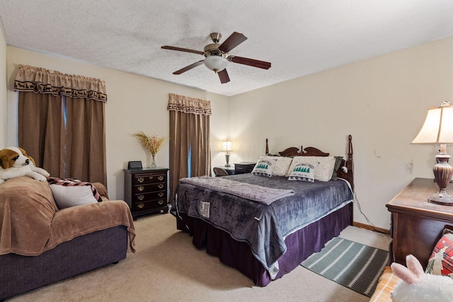 bedroom featuring ceiling fan, light carpet, and a textured ceiling