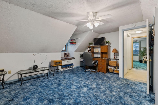 carpeted office space with ceiling fan, lofted ceiling, and a textured ceiling