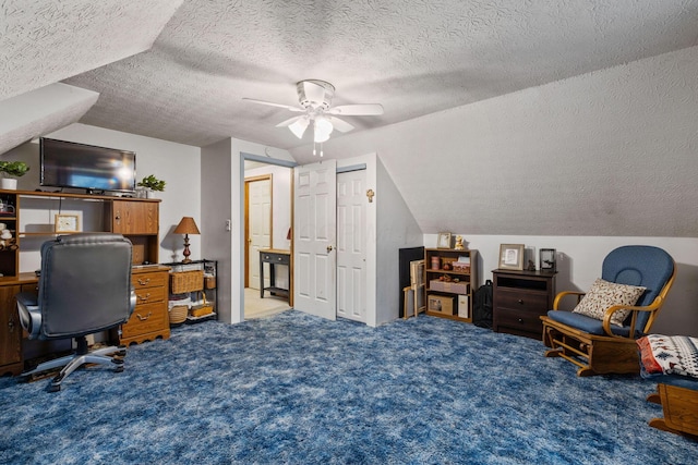 bedroom with ceiling fan, lofted ceiling, carpet flooring, and a textured ceiling