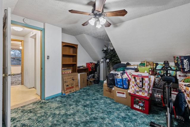 bonus room featuring lofted ceiling, ceiling fan, a textured ceiling, and carpet flooring