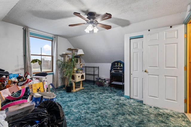 bonus room featuring dark colored carpet, lofted ceiling, ceiling fan, and a textured ceiling