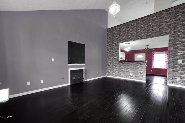 unfurnished living room featuring hardwood / wood-style flooring, high vaulted ceiling, and ceiling fan