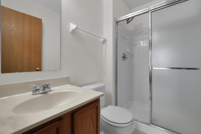 bathroom featuring vanity, toilet, and walk in shower