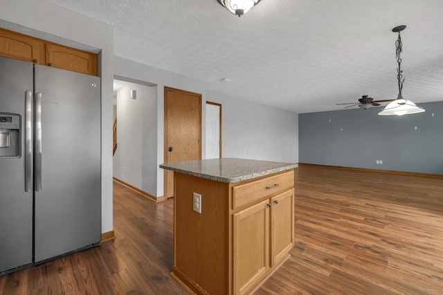 kitchen with a textured ceiling, a kitchen island, dark wood-type flooring, and stainless steel fridge with ice dispenser