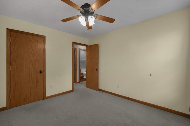 unfurnished bedroom featuring carpet floors, a closet, ceiling fan, and baseboards