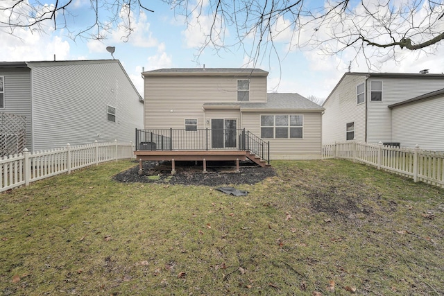 back of house featuring a yard, a fenced backyard, and a wooden deck