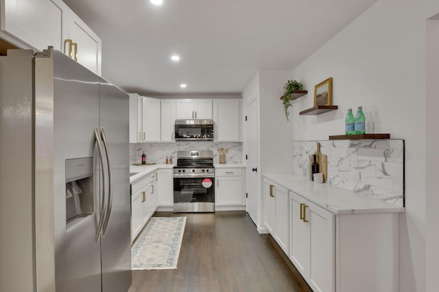 kitchen featuring decorative backsplash, dark wood-type flooring, stainless steel appliances, and white cabinets