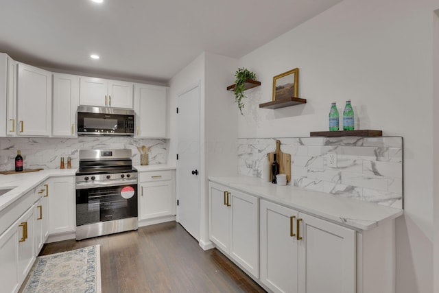 kitchen with stainless steel appliances, white cabinetry, dark wood-type flooring, and decorative backsplash