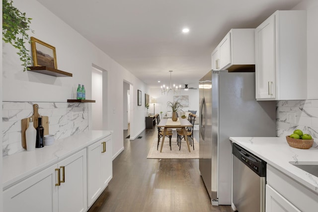 kitchen with decorative light fixtures, dark hardwood / wood-style floors, dishwasher, and white cabinets