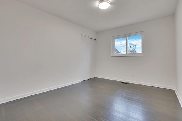 empty room featuring dark hardwood / wood-style flooring