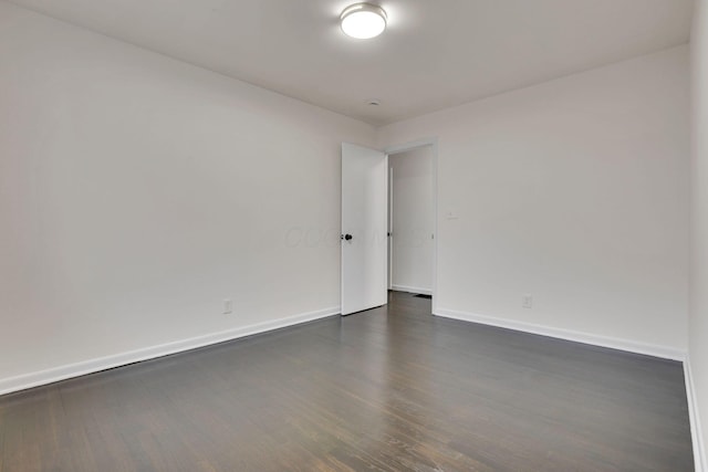 unfurnished room featuring dark wood-type flooring