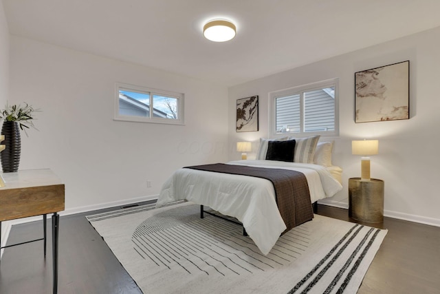 bedroom with dark hardwood / wood-style flooring