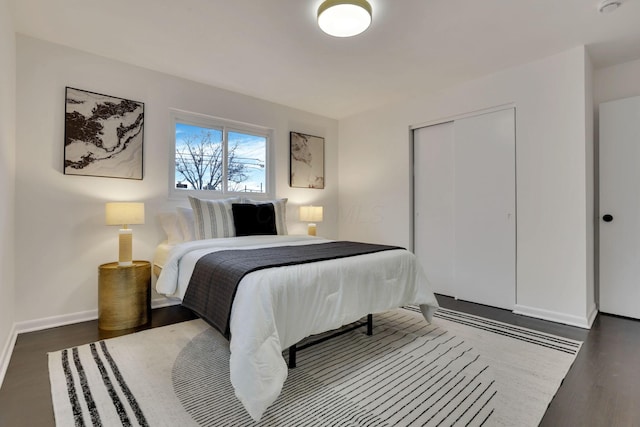 bedroom featuring dark hardwood / wood-style flooring and a closet