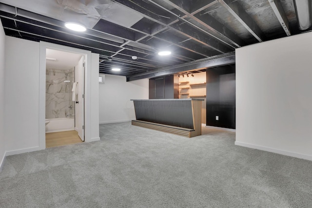 basement with bar and carpet