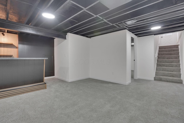 basement with carpet flooring and bar area