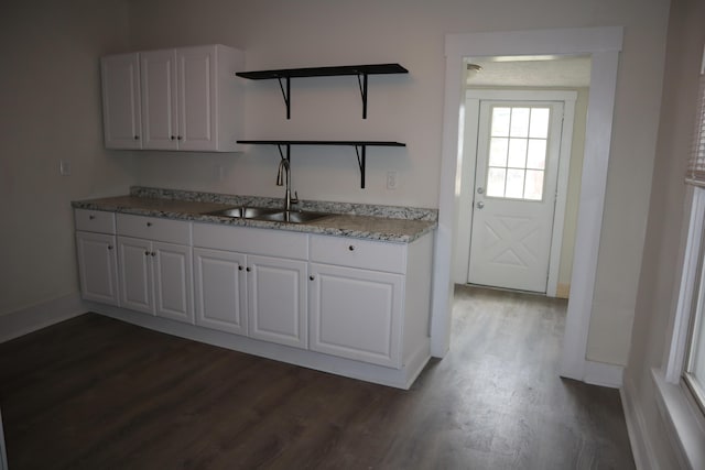 kitchen featuring white cabinetry, dark wood-type flooring, and sink