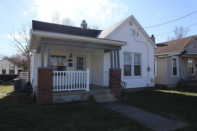 bungalow-style home with central AC unit and covered porch