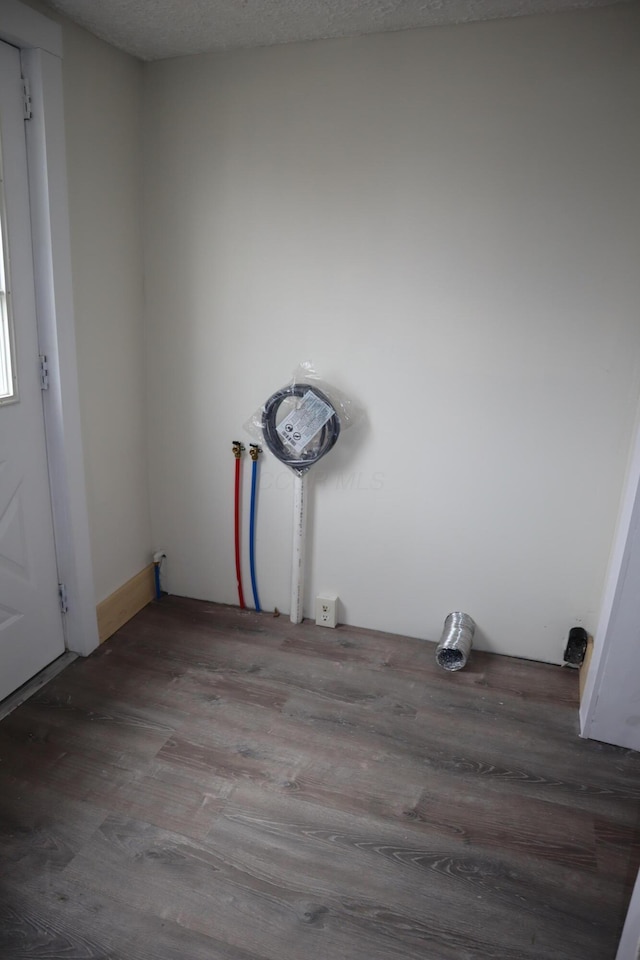 empty room with wood-type flooring and a textured ceiling