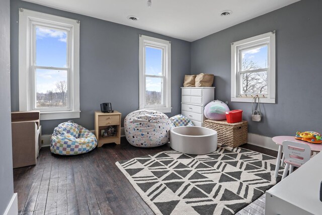 recreation room with dark hardwood / wood-style floors and a wealth of natural light