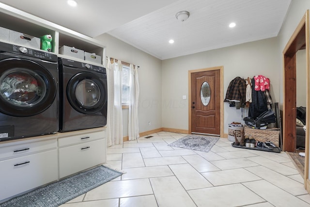 laundry area with light tile patterned floors, recessed lighting, separate washer and dryer, laundry area, and baseboards