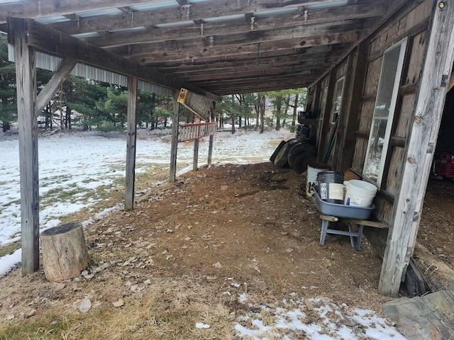 snowy yard featuring a carport