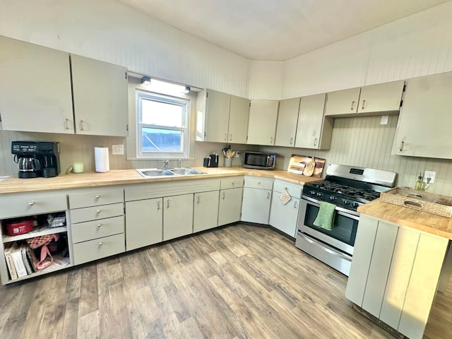 kitchen featuring stainless steel appliances, light wood-type flooring, and a sink