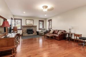 living room with hardwood / wood-style flooring and ceiling fan