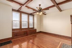 unfurnished room featuring beamed ceiling, ceiling fan, coffered ceiling, and hardwood / wood-style floors