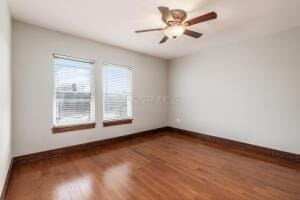 spare room with hardwood / wood-style flooring and ceiling fan