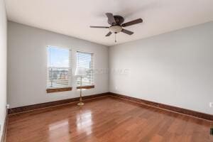 spare room with wood-type flooring and ceiling fan