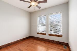 unfurnished room with hardwood / wood-style floors and ceiling fan