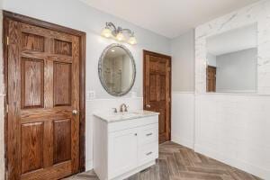 bathroom featuring parquet floors and vanity