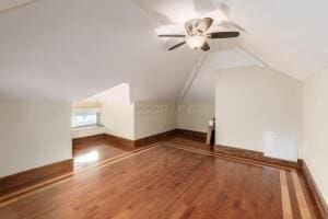 bonus room with vaulted ceiling and hardwood / wood-style floors