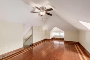 additional living space featuring wood-type flooring, lofted ceiling, and ceiling fan