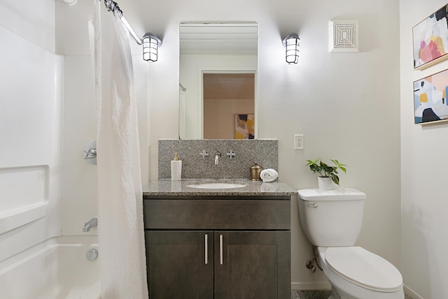 full bathroom featuring tasteful backsplash, vanity, tub / shower combination, and toilet