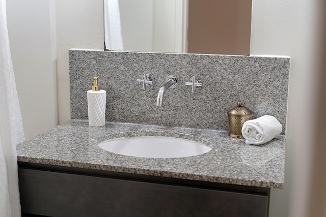 bathroom featuring vanity and decorative backsplash