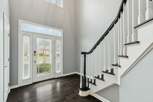 entrance foyer with dark wood-type flooring and a high ceiling